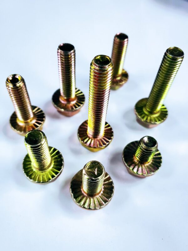 A group of yellow metal nuts and bolts.