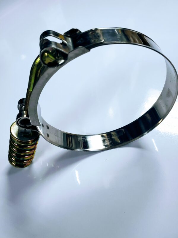 A metal hose clamp with a light hanging from it.