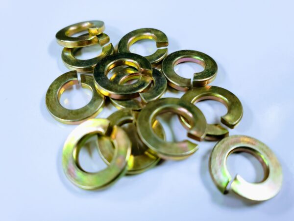 A bunch of metal washers are laying on the table