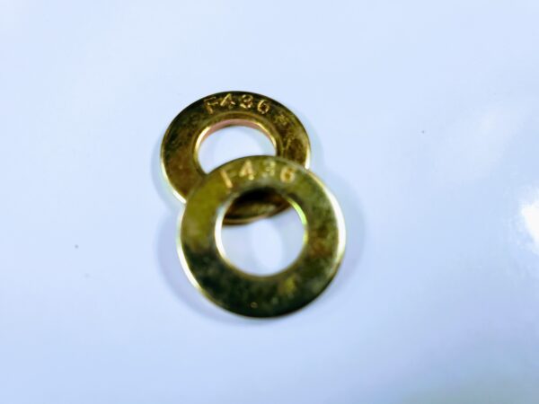 A pair of brass washers sitting on top of a table.